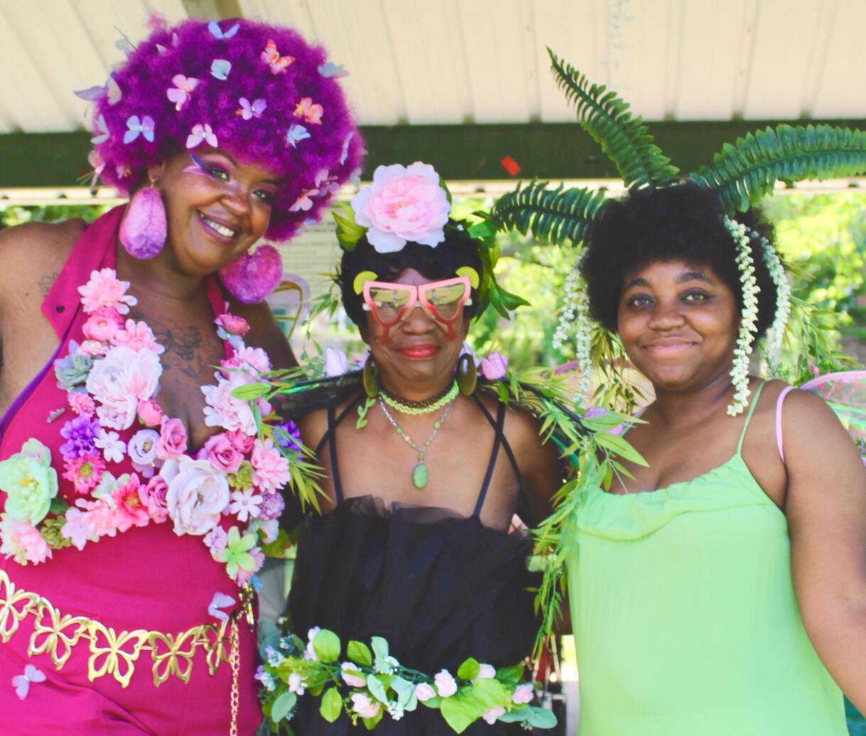 3 faebulous fae smiling a the camera and holding each other.