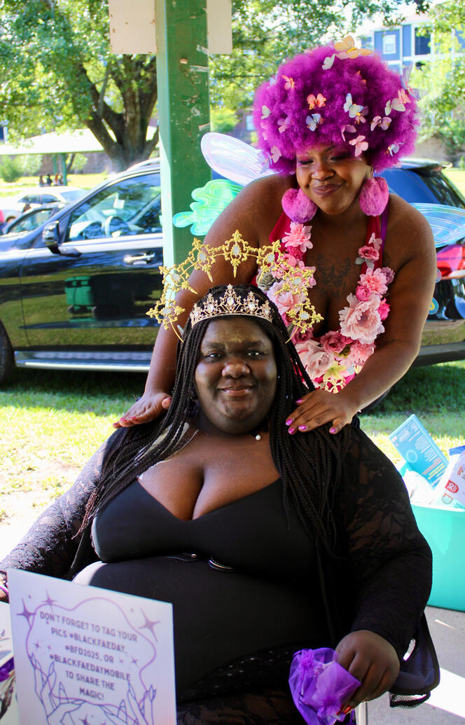 Faebulous siblings posing together. The dark fae royalty in the chair with the blossoming fae behind her with hands on her sisters shoulder.