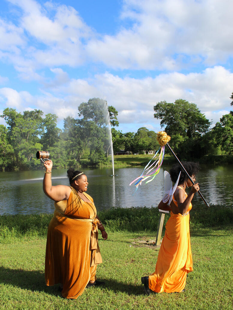 a golden fae running with the scepter of a golden goddess with a mug in pursuit.