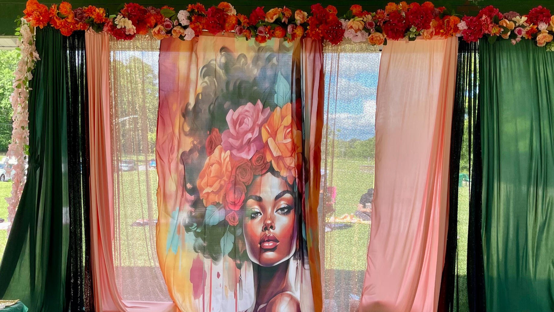 sheer backdrop of black woman portrait with curly fro surrounded by flowers and designed by Dees edible elegance