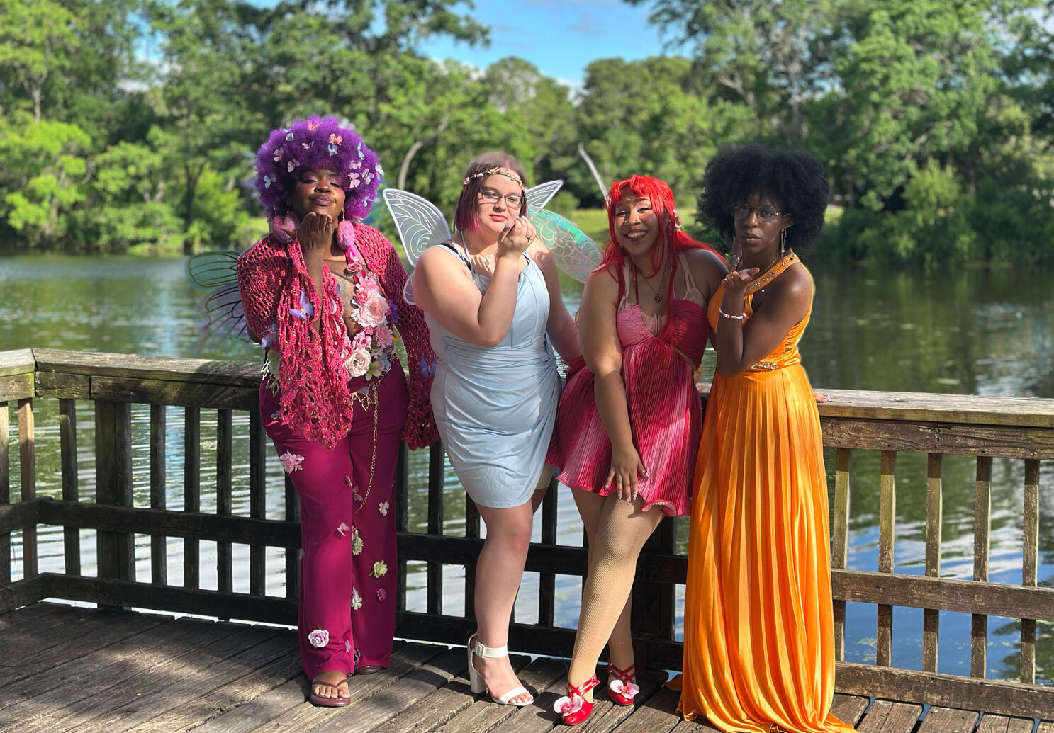 fae blowing kisses and posing on the pier over the lake.