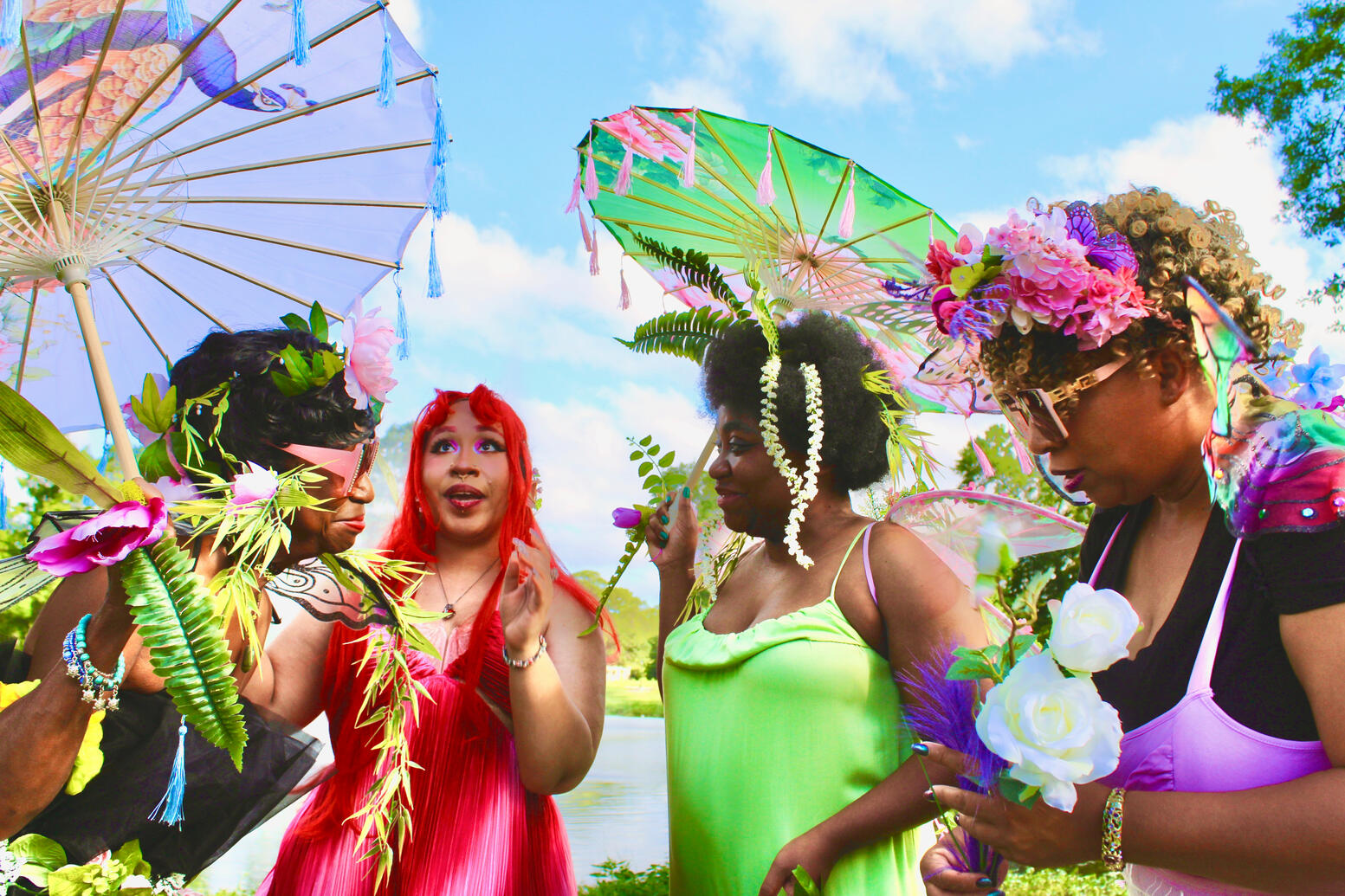 Faye in conversation under a bright blue cloudy sky.