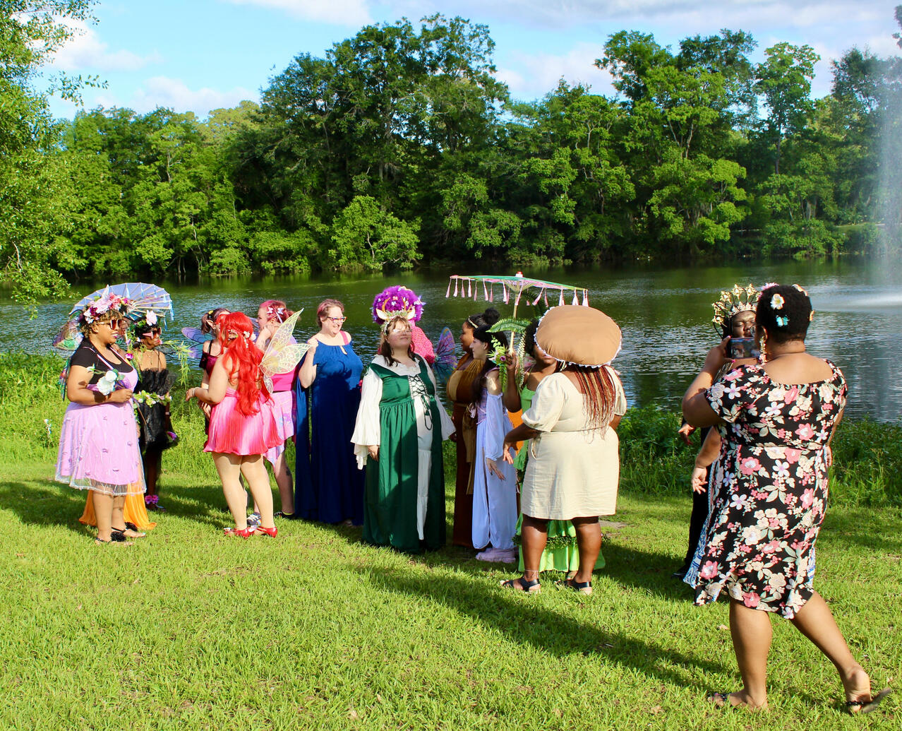 Fae folk gathering for a group photo by the lake