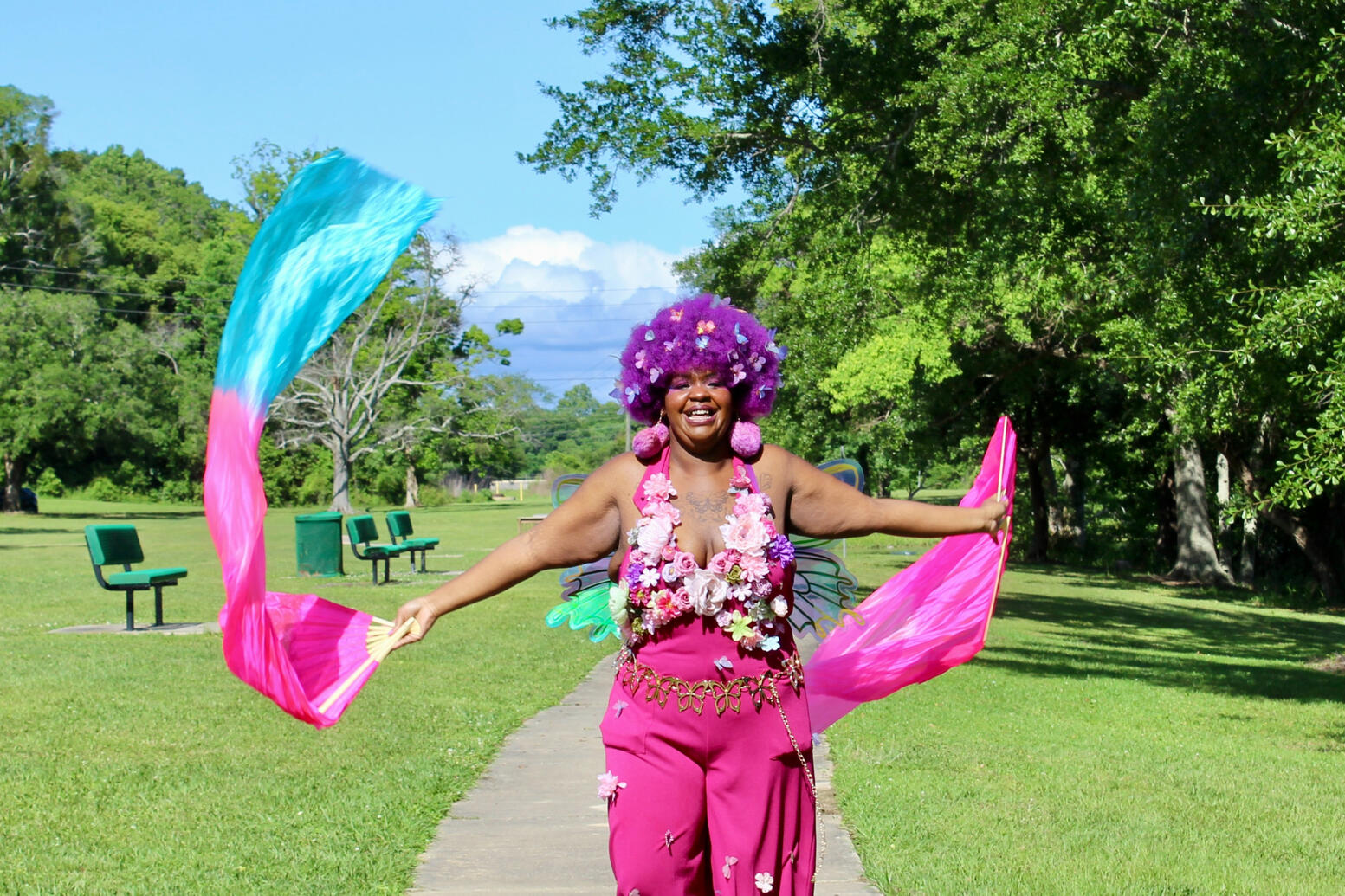 Fae fan dancing and facing the camera with big smile.